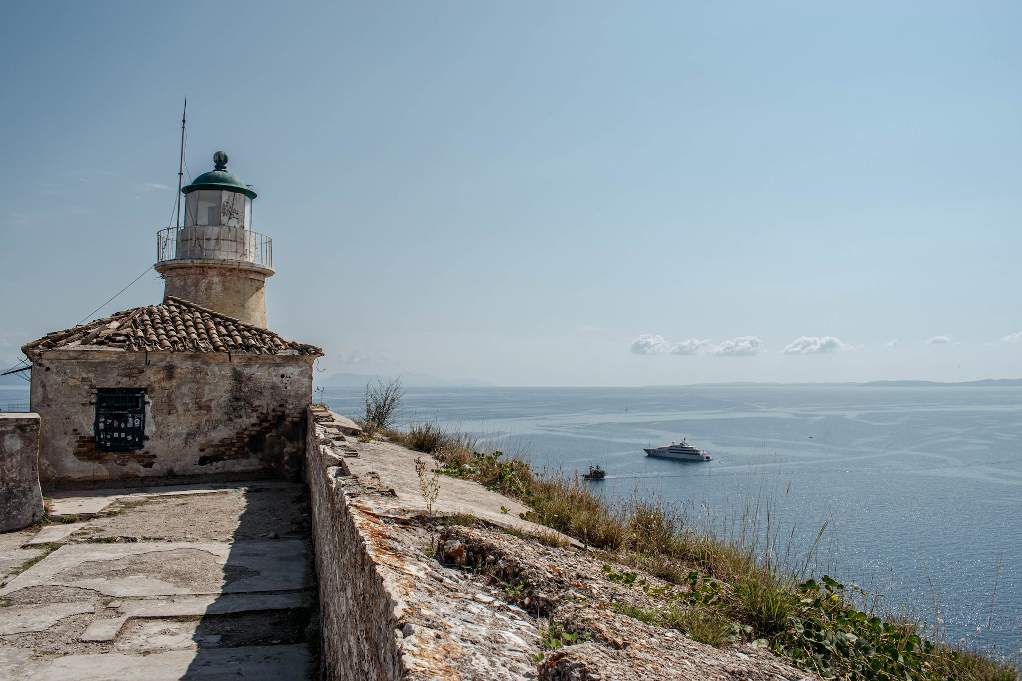 A lighthouse sits on a rocky cliff overlooking the ocean